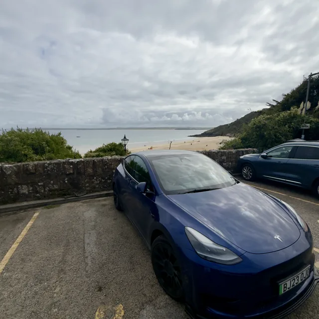 EV Rider Tesla overlooking the beach in St Ives, Cornwall